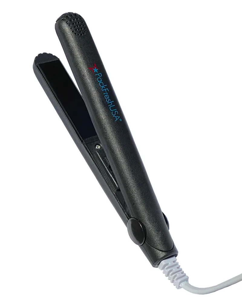 A PackFreshUSA mini bag sealer standing upright with its jaws open and its cord trailing.